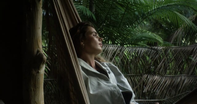 Woman lying on a hammock in the jungle