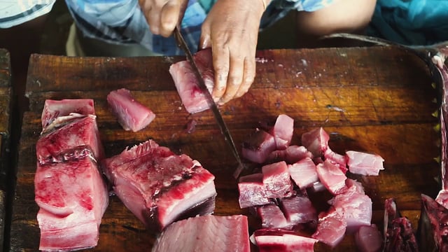 Woman cutting tuna