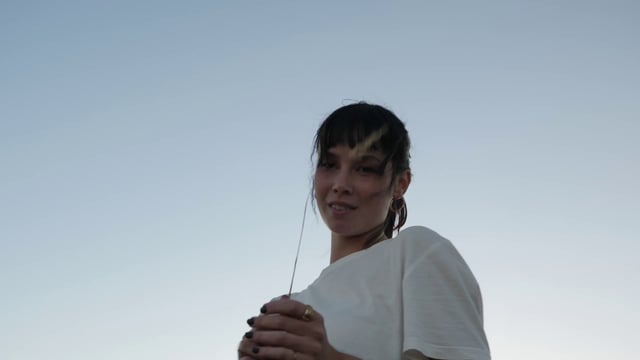 Woman holds grass up to the camera