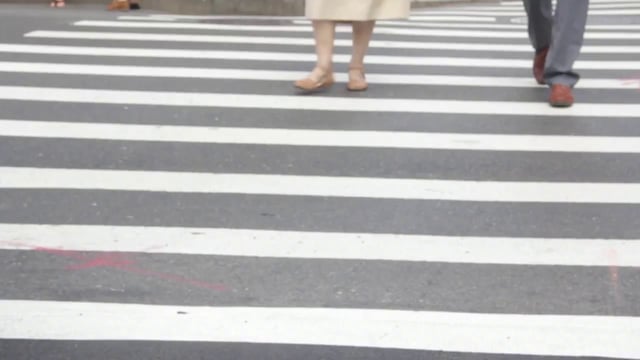 Couple walking on a pedestrian crossing