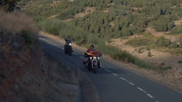 Motorcyclists riding together on a downhill road
