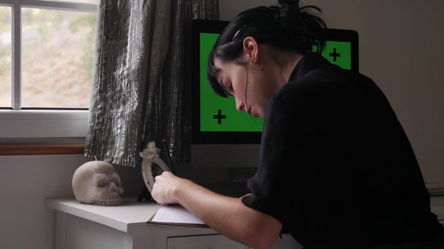 Freelancer writing in notebook