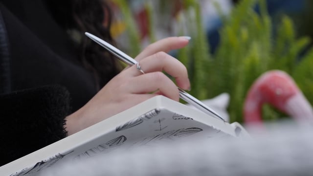 Girl drawing in a notebook